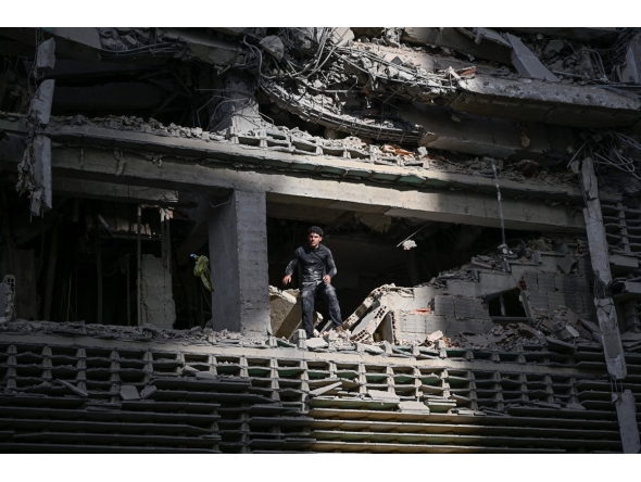 A man looks out from a damaged apartment building following an earthquake in Catia La Mar, La Guaira state, some 30km north-west of Caracas, on June 25, 2026. Photo by FEDERICO PARRA / AFP