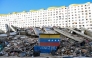 A Venezuelan flag is seen painted on a damaged wall amid the rubble of a collapsed building following earthquakes in Caraballeda, La Guaira state, Venezuela, on June 26, 2026. (Photo by Maryorin Mendez / AFP)