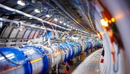 (Files) The 1232 dipole magnets that bend the path of accelerated protons are pictured in the Large Hadron Collider (LHC) in a tunnel of the European Organisation for Nuclear Research (CERN), during maintenance works on February 6, 2020 in Echenevex, France, near Geneva. (Photo by Vlentin Flauraud / AFP)
