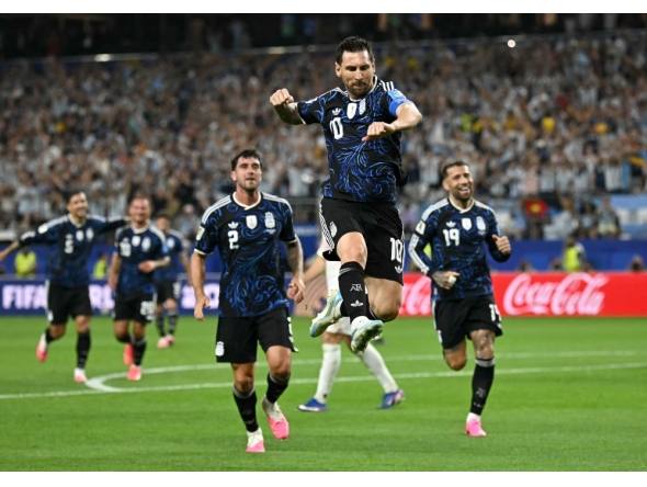 Argentina's forward #10 Lionel Messi celebrates scoring his team's third goal. (Photo by Paul Ellis / AFP)