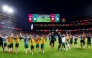 Australia players celebrate after qualifying for the Round of 32. (AFP)
