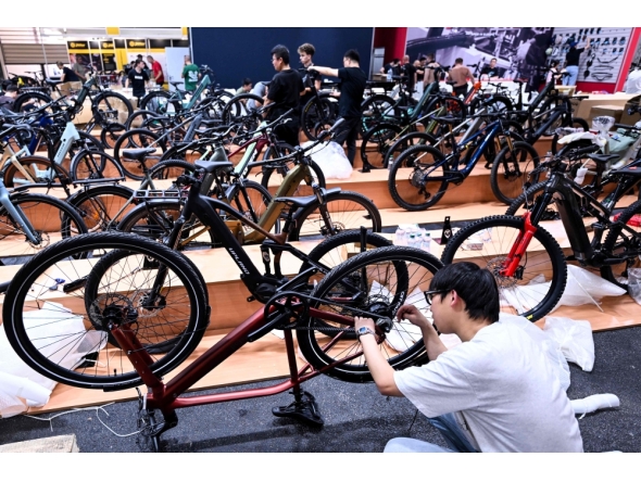 An employee prepares a booth at the EUROBIKE 2026 fair of the international bicycle industry in Frankfurt am Main, western Germany on June 23, 2026. (Photo by Kirill Kudryavtsev / AFP)