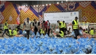 Representatives of QRCS and JHCO preparing vegetable parcels.