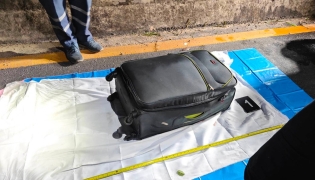 In this handout photo taken in Pattaya on June 27, 2026 and provided by Pattaya City Police Station on June 29, police officers measure a suitcase after the suspected murder of a 17-year-old Thai girl. (Photo by Handout / Pattaya City Police Station / AFP)