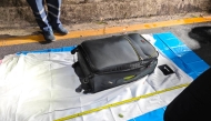 In this handout photo taken in Pattaya on June 27, 2026 and provided by Pattaya City Police Station on June 29, police officers measure a suitcase after the suspected murder of a 17-year-old Thai girl. (Photo by Handout / Pattaya City Police Station / AFP)
