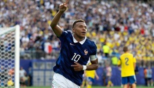 Kylian Mbappe #10 of France celebrates scoring his team's third goal. Al Bello/Getty Images/AFP