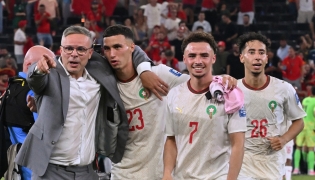 Morocco’s head coach Mohamed Ouahbi (left) celebrates with his players after they defeated the Netherlands. (AFP)