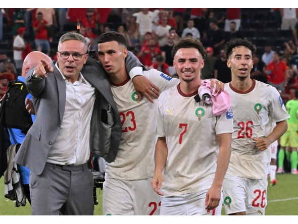 Morocco’s head coach Mohamed Ouahbi (left) celebrates with his players after they defeated the Netherlands. (AFP)