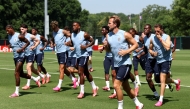England's Harry Kane and teammates warm up during a training session. (AFP)