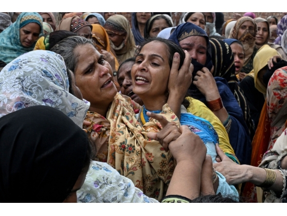 Relatives mourn the deceased children before their burial in Lahore on July 1, 2026, after the roof of a tutoring centre collapsed the previous day. Photo by Arif Ali / AFP