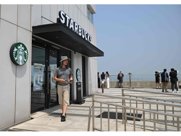 A visitor walks past a Starbucks store offering a view of North Korea at a South Korean observation deck at Aegibong Peace Ecopark in Gimpo on July 1, 2026. Photo by Jung Yeon-je / AFP