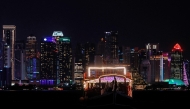 Illuminated skyscrapers are pictured along the corniche promenade in Doha on June 29, 2026. (Photo by Karim Jaafar / AFP)
