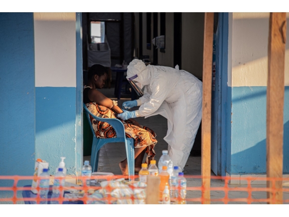 A healthcare worker takes samples from a patient suffering from Ebola virus disease at the Ebola Treatment Center of the Center Médical Évangélique (CME), in Bunia, Ituri, in the east of the Democratic Republic of Congo on June 23, 2026. (Photo by Benediction MURHABAZI / AFP)