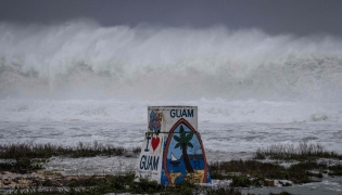 High waves crash against the coastline at a beach as the forecasted Super Typhoon Bavi approaches in Guam on July 5, 2026. (Photo by Yuichi YAMAZAKI / AFP)