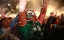 A masked Mexican football fan reacts as they watch the 2026 FIFA World Cup Round of 16 football match between Mexico and England at the Angel of Independence in Mexico City on July 5, 2026. (Photo by Claudia Rosel / AFP)