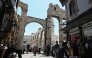 Shoppers walk through an old market area near the Umayyad Mosque in Damascus on July 9, 2026. (Photo by Louai Beshara / AFP)