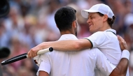 Italy's Jannik Sinner winks at Serbia's Novak Djokovic after beating him during their men's singles semi-final tennis match on the twelfth day of the 2026 Wimbledon Championships at The All England Lawn Tennis and Croquet Club in Wimbledon, southwest London, on July 10, 2026. (Photo by Kirill KUDRYAVTSEV / AFP) 