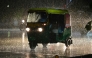 Commuters ride along a street during rainfall in Ahmedabad on July 18, 2026. (Photo by Shammi MEHRA / AFP)