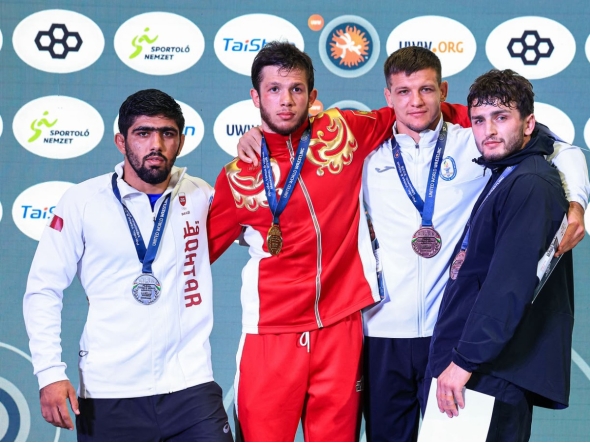 Qatar wrestler Shahin Eidimohammad Badaghimofrad (left) poses with the 82kg medal winners during the podium ceremony after claiming silver medal. 