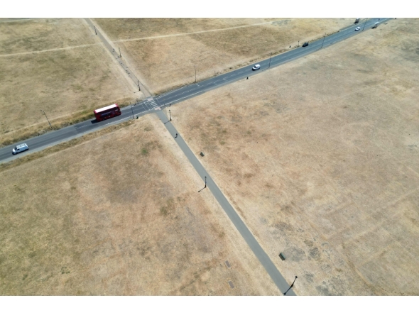 This aerial image shows a red London bus driving past the scorched grass on Blackheath in south east London, on July 29, 2026. (Photo by Justin Tallis / AFP)