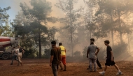 Volunteers and firefighters battle a wildfire in Fethiye, in the province of Mugla, southwestern Turkey on July 30, 2026. (Photo by Murat Kocabas / AFP)