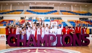 Bahrain players celebrate with their trophy and medals.