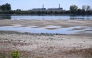 :The dried-up Danube riverbed is pictured with the Paks power plant at the background, near Dunaszentbenedek, close to Paks town on July 31, 2026. (Photo by Attila KISBENEDEK / AFP)