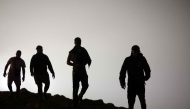 Migrants walk towards the Fnideq region in northern Morocco after leaving Spain's North African enclave of Ceuta near the town of Fnideq, on the Morocco-Spain border, following an attempted to cross at the Bab Sebta border crossing, on the Morocco- (Photo by Abdel Majid BZIOUAT / AFP)
