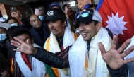 Nepali mountaineer Nirmal Purja (R) talks to the media along with his team at the Tribhuvan International airport after becoming the first to summit Pakistan's K2 mountain in winter, in Kathmandu on January 26, 2021. Photo by PRAKASH MATHEMA / AFP