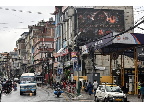 A digital billboard (top, R) displays the condolences after the death of mountaineer Nirmal Purja and his companions by an avalanche in Pakistan, in Kathmandu, on August 2, 2026. Photo by Prakash MATHEMA / AFP