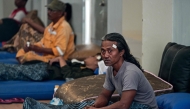 Survivors of the ferry fire recover at Tanjung Perak port in Surabaya on August 3, 2026, a day after the disaster that killed at least five people and prompted many to jump from the vessel into the sea. (Photo by JUNI KRISWANTO / AFP)
