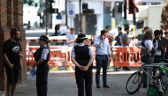 Police community support officers (PCSOs) stand behind cordon tape at Endell road in covent garden, central London on August 5, 2026. Photo by Henry NICHOLLS / AFP