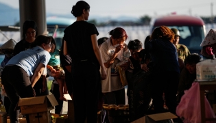 People receive relief materials at a shelter in Kumamoto Prefecture, Japan, July 30, 2026. (Xinhua/Jia Haocheng)