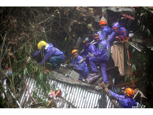 Rescuers sift through rubble as they search for survivors after a rain-drenched mountainside collapsed on several houses in Baguio City, north of Manila, on August 10, 2026. Photo by JJ LANDINGIN / AFP