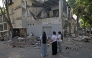 Women look at a damaged building after an earthquake in Cali, Colombia on August 10, 2026. Photo by JOAQUIN SARMIENTO / AFP