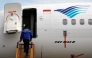 Reuters file photo for representation showing a technician boarding a parked Garuda Indonesia airplane.