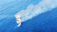 This screen grab picture from a handout video taken and released on August 12, 2026 by the Indonesian National Search and Rescue Agency (Basarnas) shows the Putri Yasmin ferry, which serves the Padangbai-Bali- to Lembar-West Nusa Tenggara route, on fire in the waters of Bali. (Photo by Handout (Green Road Waste Management ) / Indonesian National Search and Rescue Agency (BASARNAS) / AFP)
