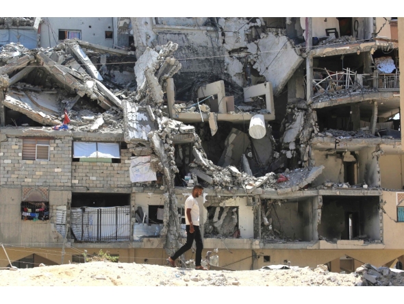 :An internally displaced Palestinian man walks past the rubble of buildings destroyed by Israeli forces in Khan Yunis southern Gaza Strip on August 11, 2026. (Photo by Bashar Taleb / AFP)