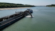 An aerial view shows a dredger deployed to deepen the navigable channel due to the low level of Danube near Capidava village, on August 12, 2026.(Photo by Daniel MIHAILESCU / AFP) 