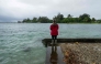 A resident looks at a young green sea turtle as ocean waters started to raise due to the approach of Tropical Storm Lala at Reed's Bay in Hilo, Hawaii on August 14, 2026. (Photo by Jill K. Briggs / AFP)
 