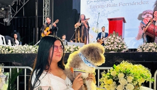 Jessica Florez, sister-in-law of the Colombian lawyer Lenny Ruiz, who died protecting her dog Salomon, during the August 10th earthquake in Cali, holds Solomon during Ruiz's funeral in Pasto, Colombia on August 13, 2026. (Photo by Eyder Portilla / AFP)