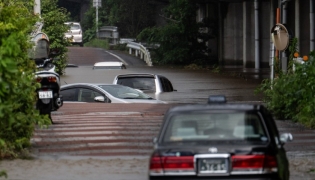 Abandoned cars partially submerged on a flooded road in Chiba prefecture. AFP file photo.