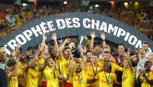 Lens' players celebrate with the championship trophy after winning the French Super Cup (Trophee des Champions) football match between RC Lens and Paris Saint-Germain (PSG) at the Stade Bollaert-Delelis in Lens, northern France on August 16, 2026. (Photo by GEOFFROY VAN DER HASSELT / AFP)