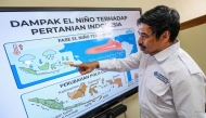 This picture taken on August 6, 2026 shows I Putu Santikayasa, hydroclimatology lecturer at IPB University, explaining the impact of El Nino in Indonesia, in Bogor, West Java. Indonesia believes cloud seeding can help it tackle a wildfire season that experts say is on track to be among the worst in years, driven by a strong El Nino. (Photo by BAY ISMOYO / AFP)
