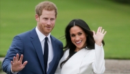 (FILES) Britain's Prince Harry and Meghan Markle pose for a photograph in the Sunken Garden at Kensington Palace in west London on November 27, 2017, following the announcement of their engagement. (Photo by Daniel LEAL / AFP)