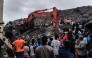 Residents and rescuers use an excavator to search for bodies after a landslide struck the Dar es Salaam dumpsite overnight in Conakry on August 23, 2026.
