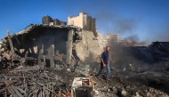 Palestinians inspect the damage at the site of an Israeli airstrike in Gaza City on August 24, 2026. (Photo by Omar AL-QATTAA / AFP)