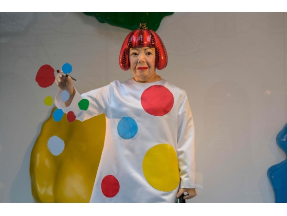 (FILE PHOTO) A life-like robot of artist Yayoi Kusama paining a window stands at the Louis Vuitton store on Fifth Avenue in New York City on January 13, 2023. (Photo by ANGELA WEISS / AFP) 