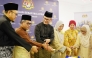Ambassador of Malaysia H E Faizal Razali with officials and community members cutting the cake.