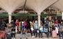Stranded passengers sit on the pavement as they wait with their luggage by the departure terminal of the Jomo Kenyatta International Airport (JKIA) after staff from the Kenya Airports Authority (KAA) and Kenya Civil Aviation Authority (KCAA) airport workers' go-slow strike action continued into its second day, in Nairobi, on August 31, 2026. Photo by SIMON MAINA / AFP
